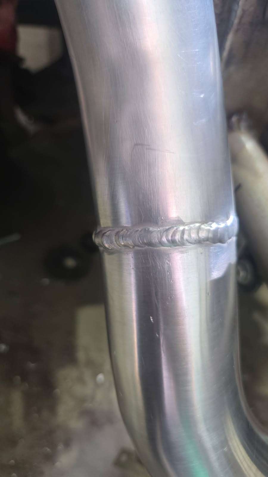 Fresh weld on a stainless truck exhaust pipe